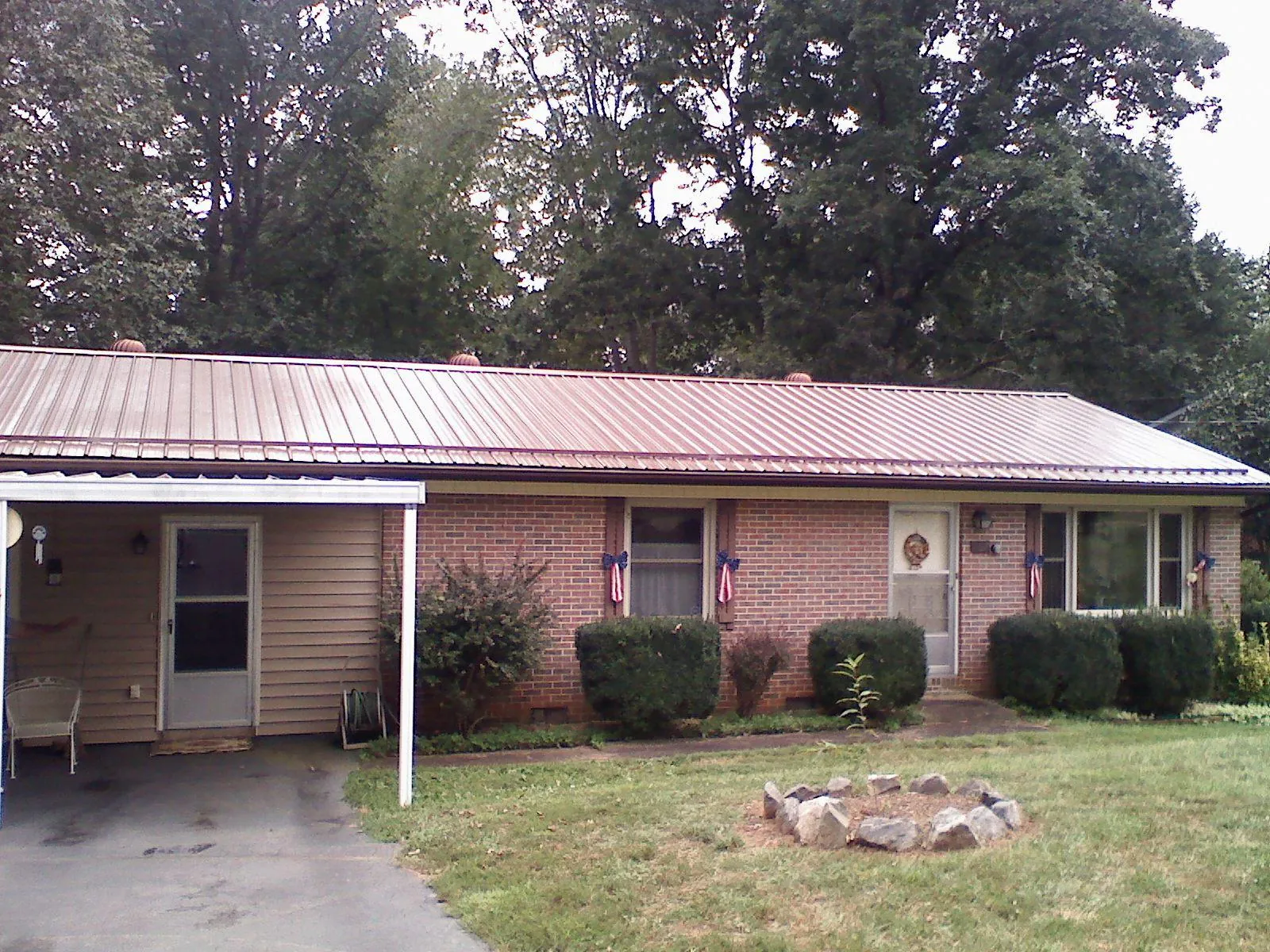 Bronze metal roof and carport on a brick ranch home — Roof Repair work by our crew in Flemington