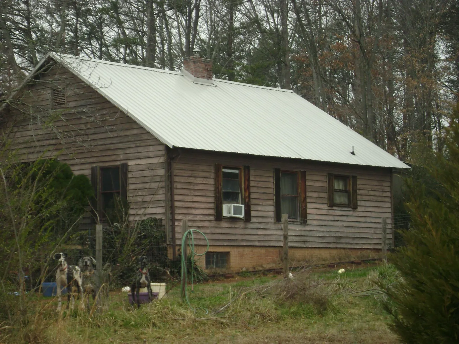 White metal roof on an old wood sided farmhouse, from a Metal Roof Installation job in Flemington